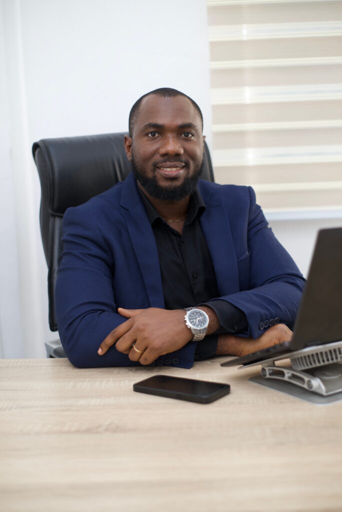African financial-services professional reviewing operational controls at a desk in Abuja